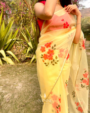 hand painted saree in pure organza silk by noor by hansa in yellow colour paired with a pure cotton blouse piece