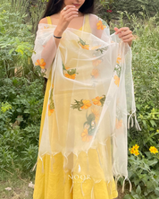 our hand painted ivory 'fanaa' odhani in pure organza silk with whimsical yellow motifs, studded with minimal gold stones and edged with fringes