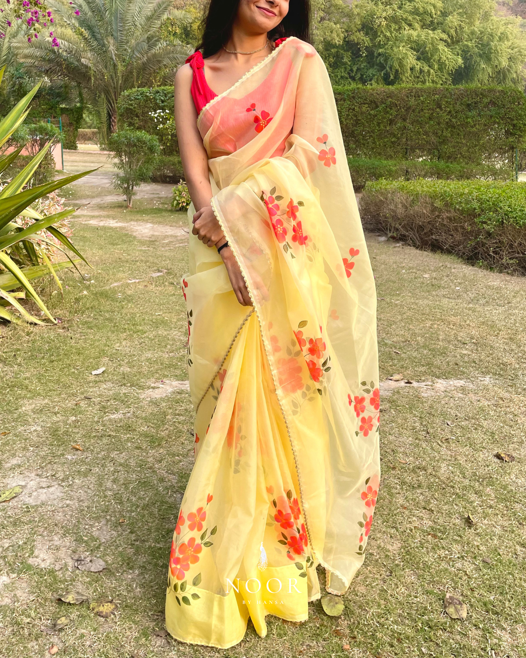 hand painted saree in pure organza silk by noor by hansa in yellow colour paired with a pure cotton blouse piece