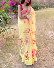 hand painted saree in pure organza silk by noor by hansa in yellow colour paired with a pure cotton blouse piece