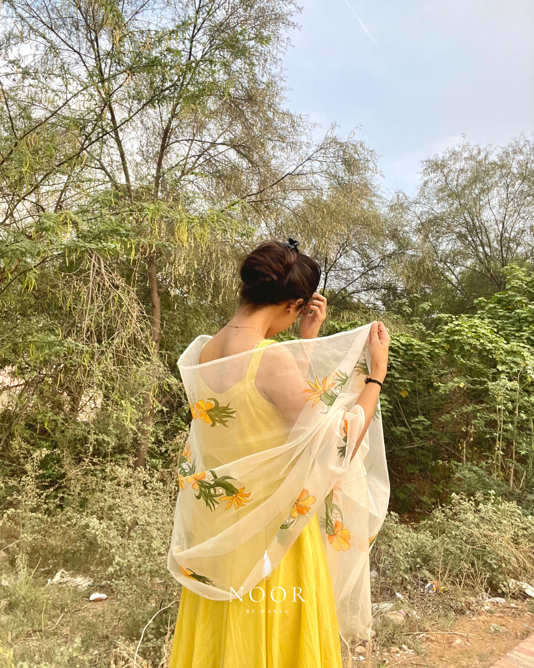 our hand painted ivory 'fanaa' odhani in pure organza silk with whimsical yellow motifs, studded with minimal gold stones and edged with fringes
