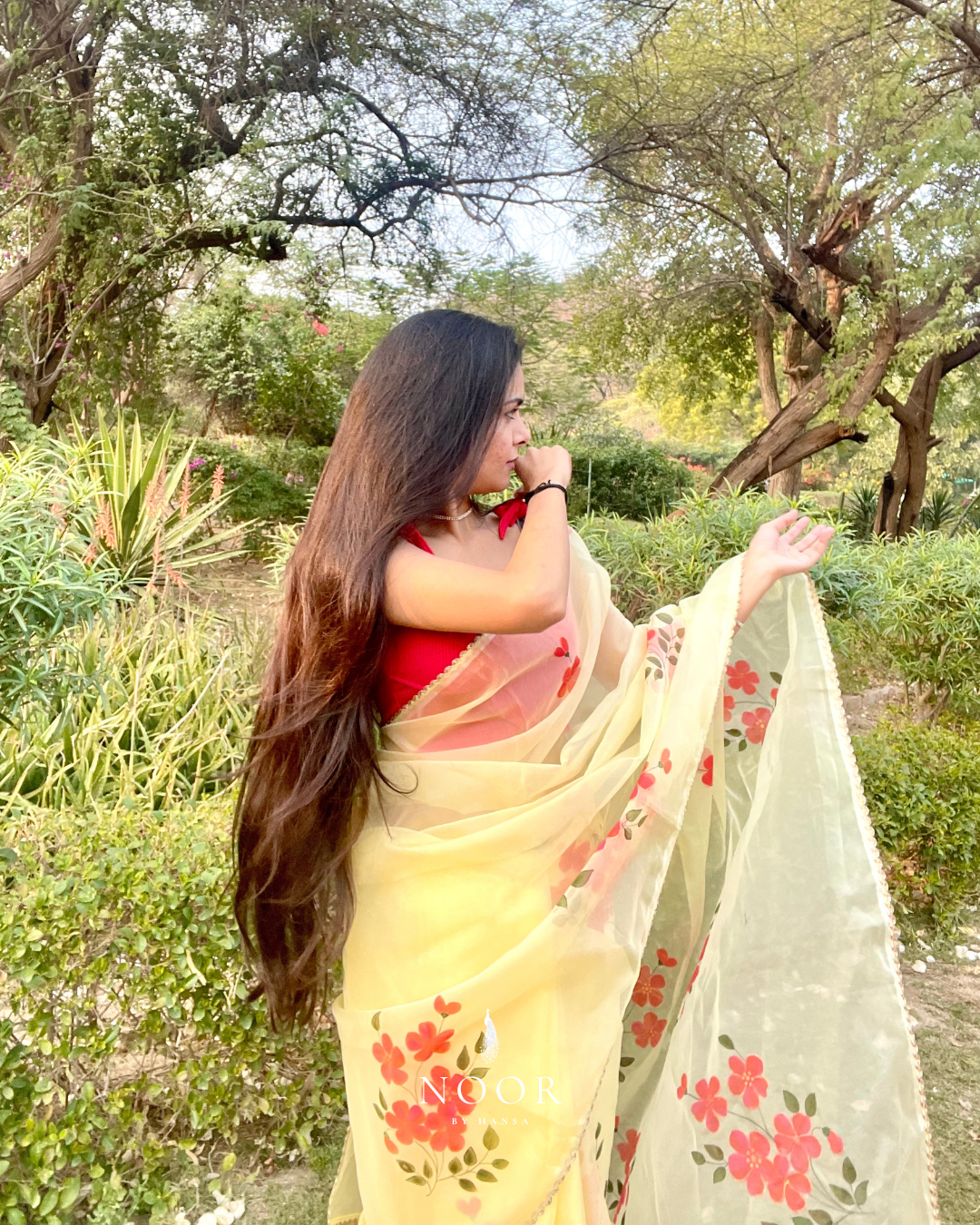 hand painted saree in pure organza silk by noor by hansa in yellow colour paired with a pure cotton blouse piece